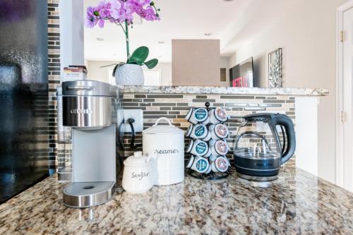 a kitchen counter with appliances on a counter top at Spacious, Relaxing & Gorgeous 4BD/4BA House in DC! in Washington, D.C.