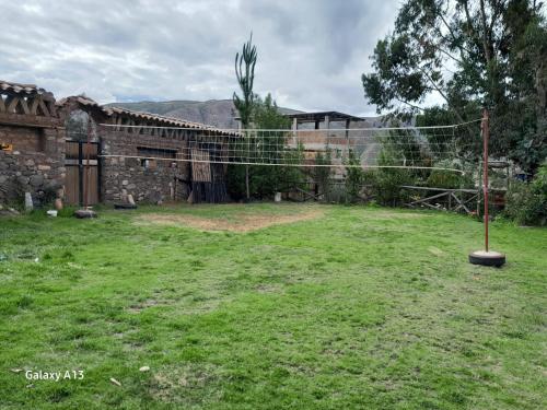 a yard with a fence in front of a building at Casa Corazao in Urubamba