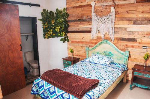 a bedroom with a wooden accent wall and a bed at flowers in Medellín
