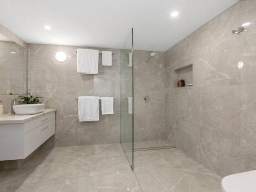 a bathroom with a shower and a sink at Sutherland Sunrise in Kingscliff