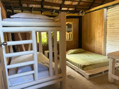 a room with two bunk beds and a bed at Punta Arena EcoHostal & EcoFit 01 in Playa Punta Arena