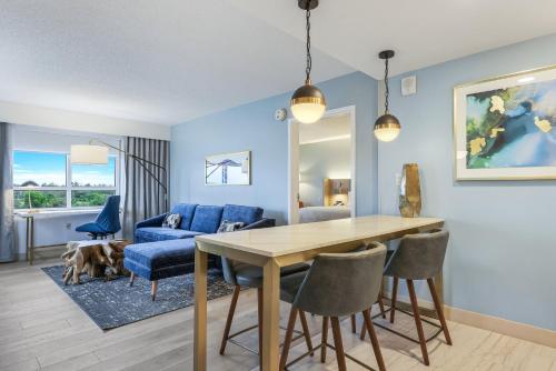 a living room with a table and a blue couch at Crowne Plaza Ft Myers Gulf Coast by IHG in Fort Myers