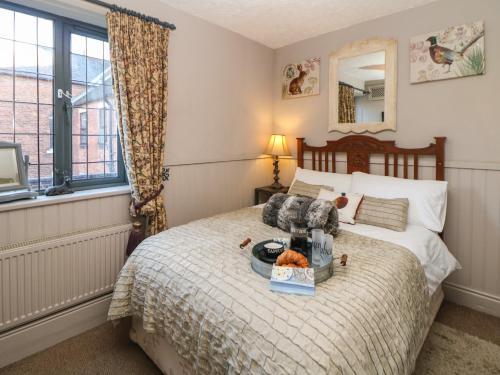 a bedroom with a bed with a tray of food on it at The Old Clock Makers in Ashbourne