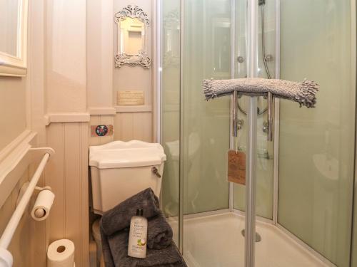 a shower with a glass door in a bathroom at The Old Clock Makers in Ashbourne