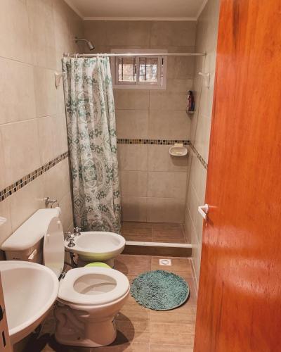 a bathroom with a toilet and a sink and a shower at Cabaña Clarita La Florida in La Florida
