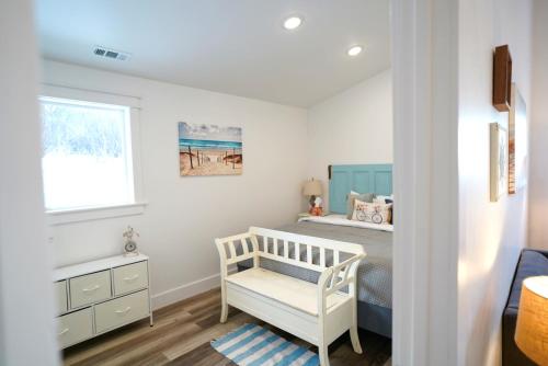 a small bedroom with a bed and a window at Bluff Hideaway - Guest House in Homer