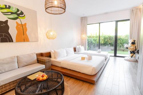 a living room with a couch and a table at Nacpan Beach Resort Managed by H Hospitality Group in El Nido