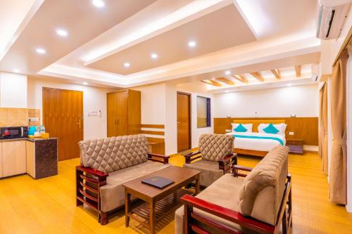 a living room with a couch and a bed at Pokhara Alpine and Springs in Pokhara