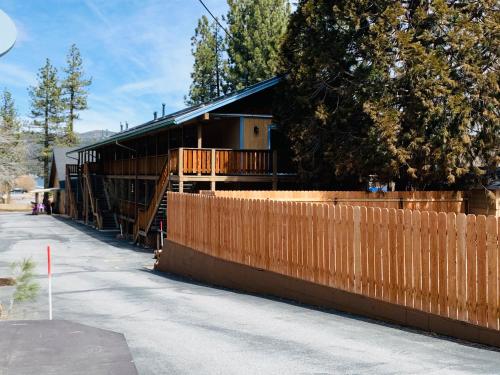 a building with a wooden fence next to a street at Snow Bear Lodge in Big Bear Lake