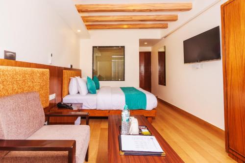 a hotel room with a bed and a couch at Pokhara Alpine and Springs in Pokhara