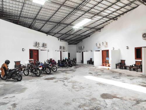 a group of motorcycles parked in a large room at RedDoorz near Prambanan Temple in Klaten