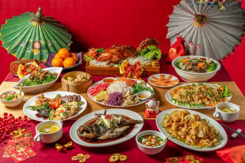 a table with many plates of food on it at Holiday Inn Cikarang Jababeka by IHG in Cikarang