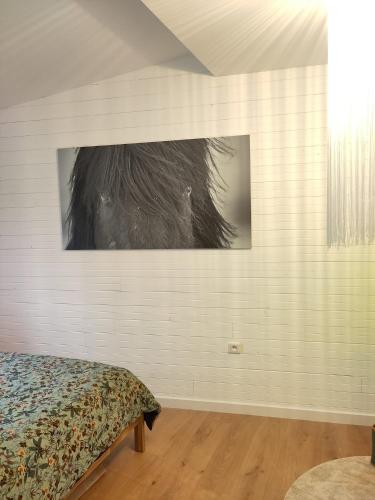a bedroom with a bed and a picture on the wall at Gîte La Lisière in Sparsbach