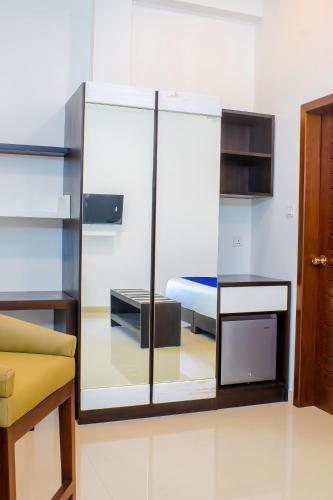 a room with a bed and a glass wall at Ceylanro Transit Villa in Negombo