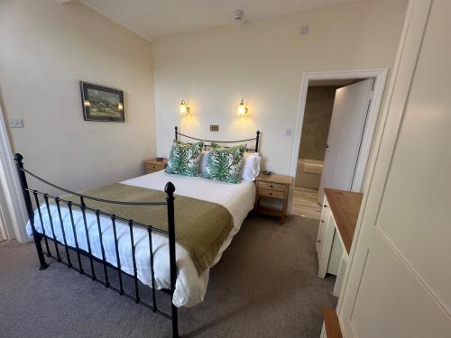 a bedroom with a large bed and a bathroom at 3 Bed in Hawkshead 88985 in Near Sawrey