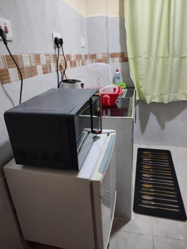 a microwave sitting on top of a counter in a kitchen at Elim apartment in Kitengela 