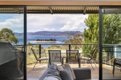 a view from the living room of a house with a large glass window at Stockyards 3 - Jindabyne Luxury Townhouse in Jindabyne