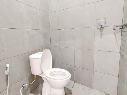 a bathroom with a white toilet in a room at RedDoorz near Prambanan Temple in Klaten