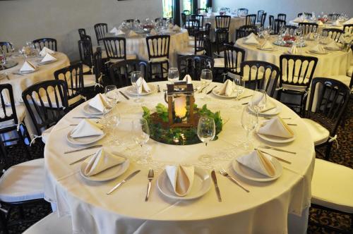 a table set up for a wedding with white table settings at Hotel Flamingo Inn in Querétaro
