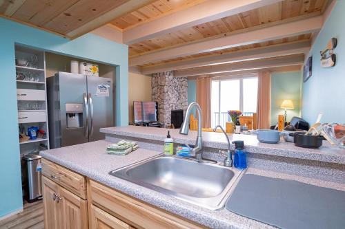 a kitchen with a sink and a refrigerator at Tahoe Waterfront Condo with Boat Dock in South Lake Tahoe