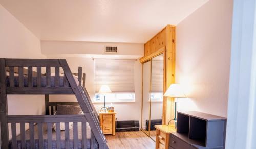 a room with a bunk bed and a ladder at Tahoe Waterfront Condo with Boat Dock in South Lake Tahoe