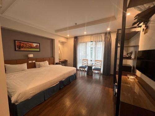 a bedroom with a large bed and a large window at A25 Hotel - 187 Trung Kính in Hanoi