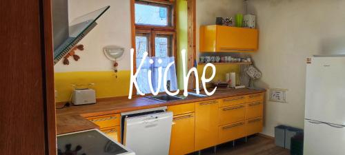 a kitchen with a counter with neon signs on it at Ferienwohnungen Rosi in Kleblach