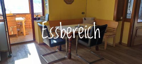 a restaurant sign on a table in a room at Ferienwohnungen Rosi in Kleblach