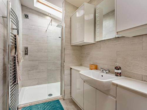 a white bathroom with a sink and a shower at 3 Bed in Livingston 91829 in Forth