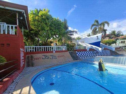 a swimming pool at a resort with a slide at JSJS Mountain Resort powered by Cocotel in Talaga