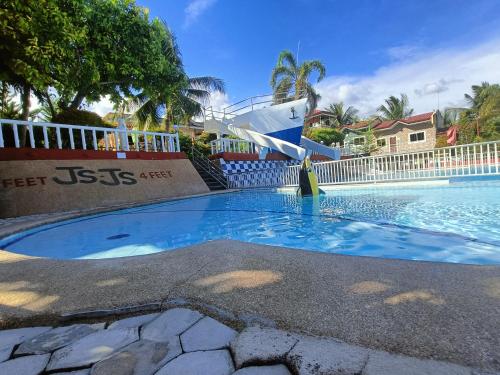 a swimming pool with a cruise ship in the background at JSJS Mountain Resort powered by Cocotel in Talaga