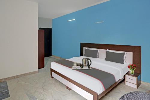 a bedroom with a large bed with a blue light at OYO Rajvanshi Residency in Gurgaon