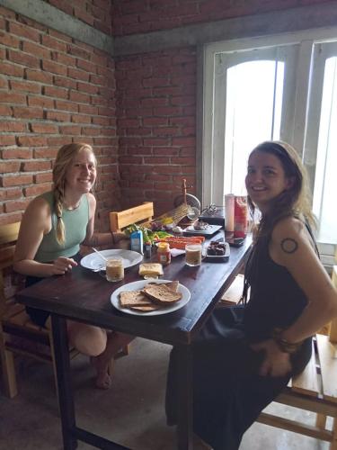 two women sitting at a table with food on it at Glenview hotel & homestay in Kandy