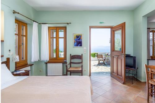 a bedroom with a bed and a view of the ocean at Stolios in Skopelos Town