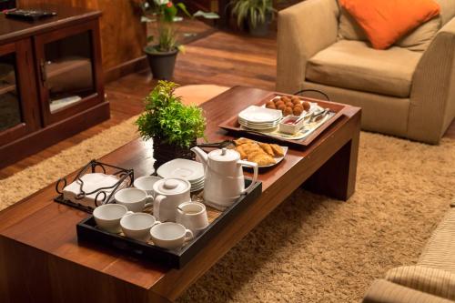 a coffee table with a tray of breakfast food on it at Iona Bungalow by Lalan Leisure in Hatton