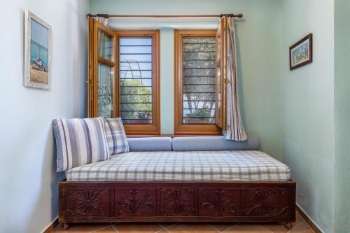 a bench in a room with a window at Stolios in Skopelos Town