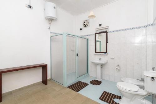 a bathroom with a shower and a toilet and a sink at Iona Bungalow by Lalan Leisure in Hatton