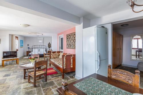 a living room with a couch and a refrigerator at Stolios in Skopelos Town