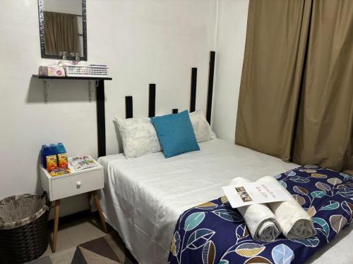 a bedroom with a bed with blue and white pillows at Cozy bedroom in Suva in Suva