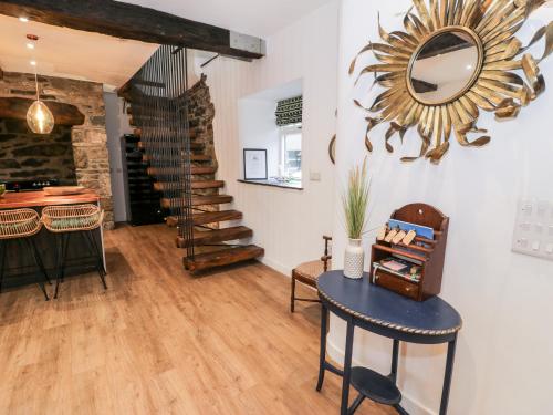 a room with a table and a mirror on the wall at Plas Glan Yr Afon in Abergele