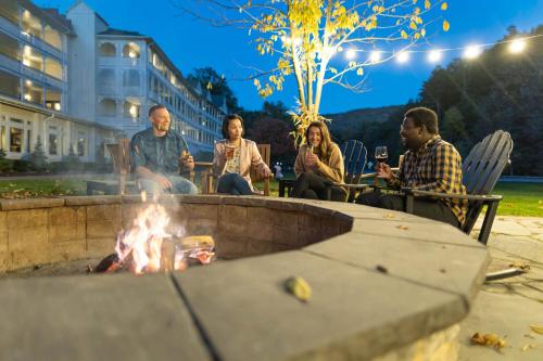 a group of people sitting around a fire pit at Omni Bedford Springs Resort & Spa in Bedford