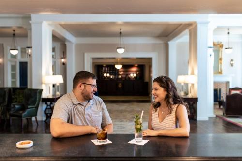 a man and a woman sitting at a table at Omni Bedford Springs Resort & Spa in Bedford