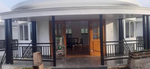 a house with a round porch with a door at COASTAL GRAND RESORT - KOTAGIRI in Kotagiri