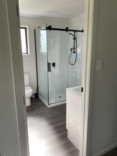 a bathroom with a glass shower and a toilet at Rural Guest Studio 