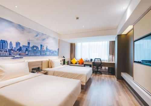 a hotel room with two beds and a flat screen tv at Atour Hotel New International Expo Center Longyang Road Shanghai in Shanghai