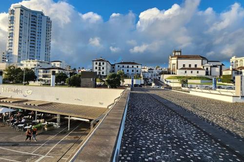 a city with a train station and buildings at Oceanview 2 Bedroom suite 5 adults PDL in Ponta Delgada
