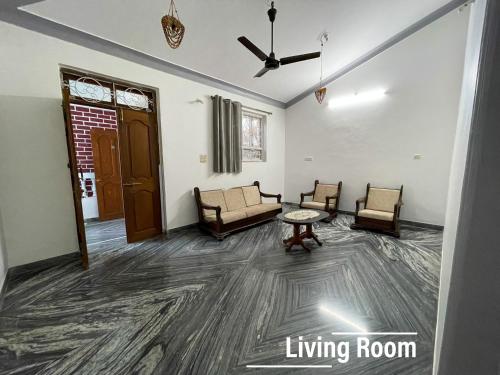 a living room with two chairs and a table at Sai Homestay Goa - Margao in Madgaon