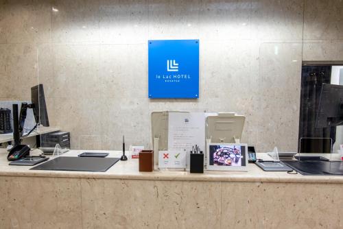 a counter with a blue sign on a wall at le Lac HOTEL KUSATSU in Kusatsu