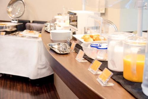 a kitchen with a counter with food and orange juice at le Lac HOTEL KUSATSU in Kusatsu