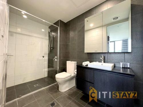 a bathroom with a toilet and a sink and a shower at Fancy in Phillip - 2bd 2bth Apt! in Phillip